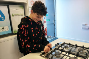 A teenage pupil testing a hydrogen gas hob
