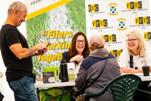Image showing Fifers for the community stall with 3 people having a discussion.